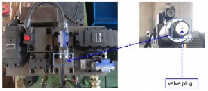 Check valve plug on hydraulic baler